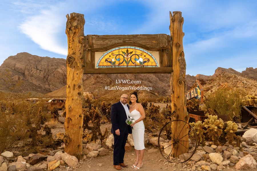 Couple beneath a rustic wooden sign with stained glass at Nelson Ghost Town, Nevada