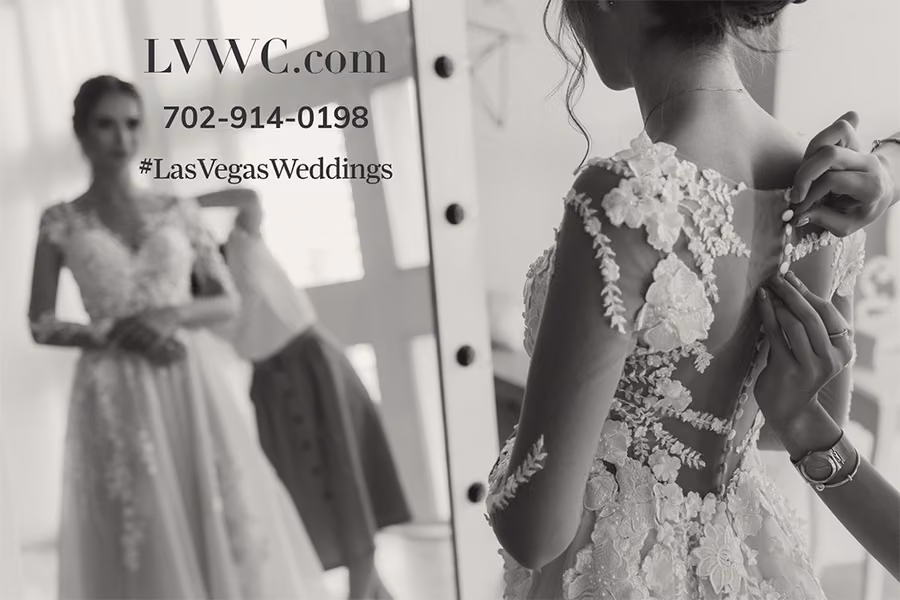 Bride having her wedding gown buttoned in a mirror reflection