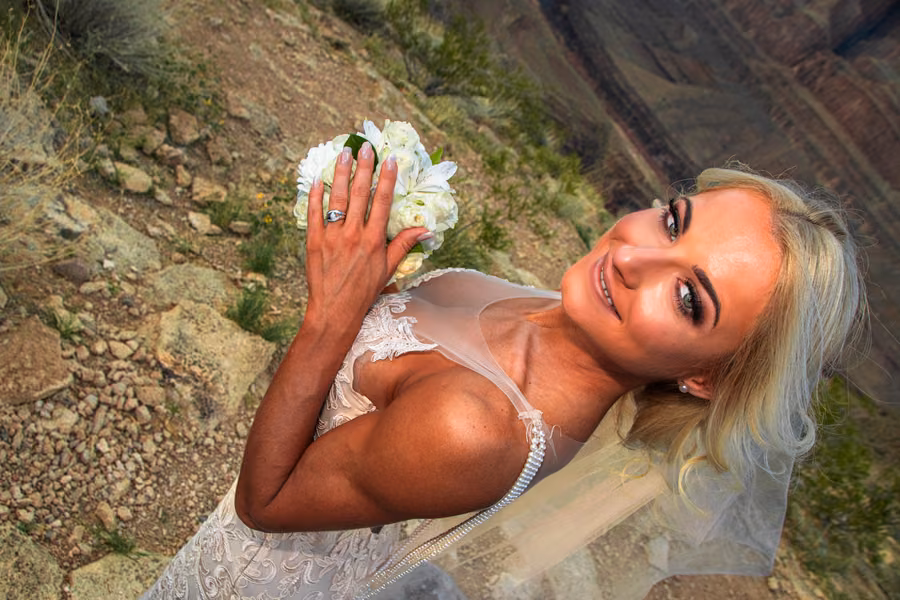 Bride showing wedding ring and bouquet at the Grand Canyon