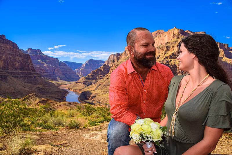 Newlyweds embracing at the Grand Canyon rim, Las Vegas helicopter wedding
