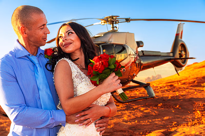Helicopter wedding couple on red rock plateau at Valley of Fire Nevada at sunset