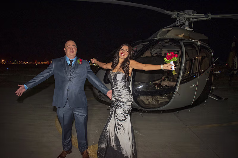 Newlyweds celebrating after helicopter wedding ceremony over Las Vegas